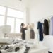 people, fashion and showroom concept - young fashion designer in her showroom