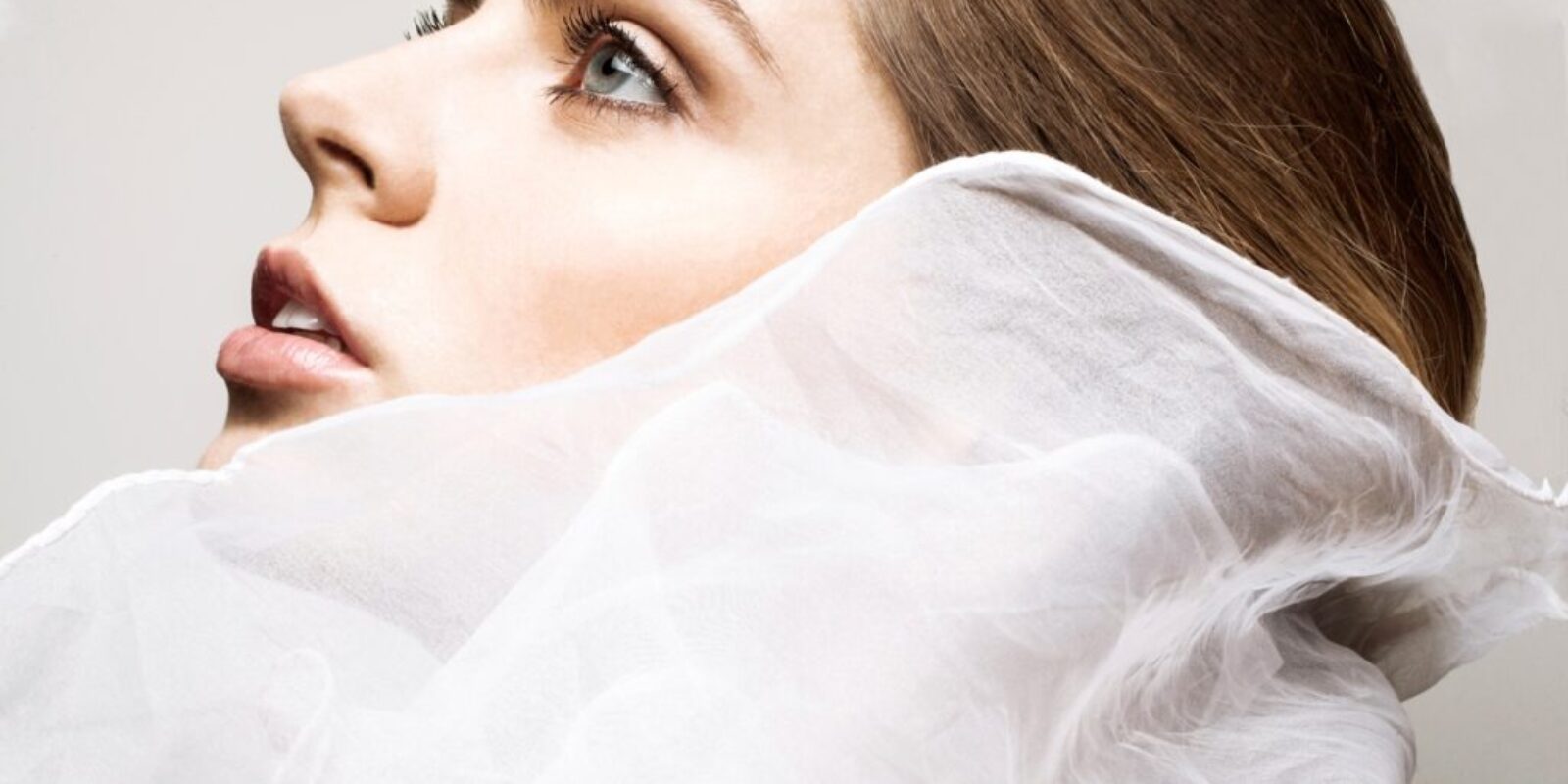 Ethereal beauty wrapped in delicate white fabric
