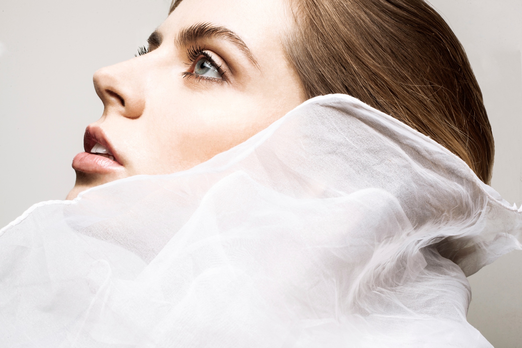 Ethereal beauty wrapped in delicate white fabric